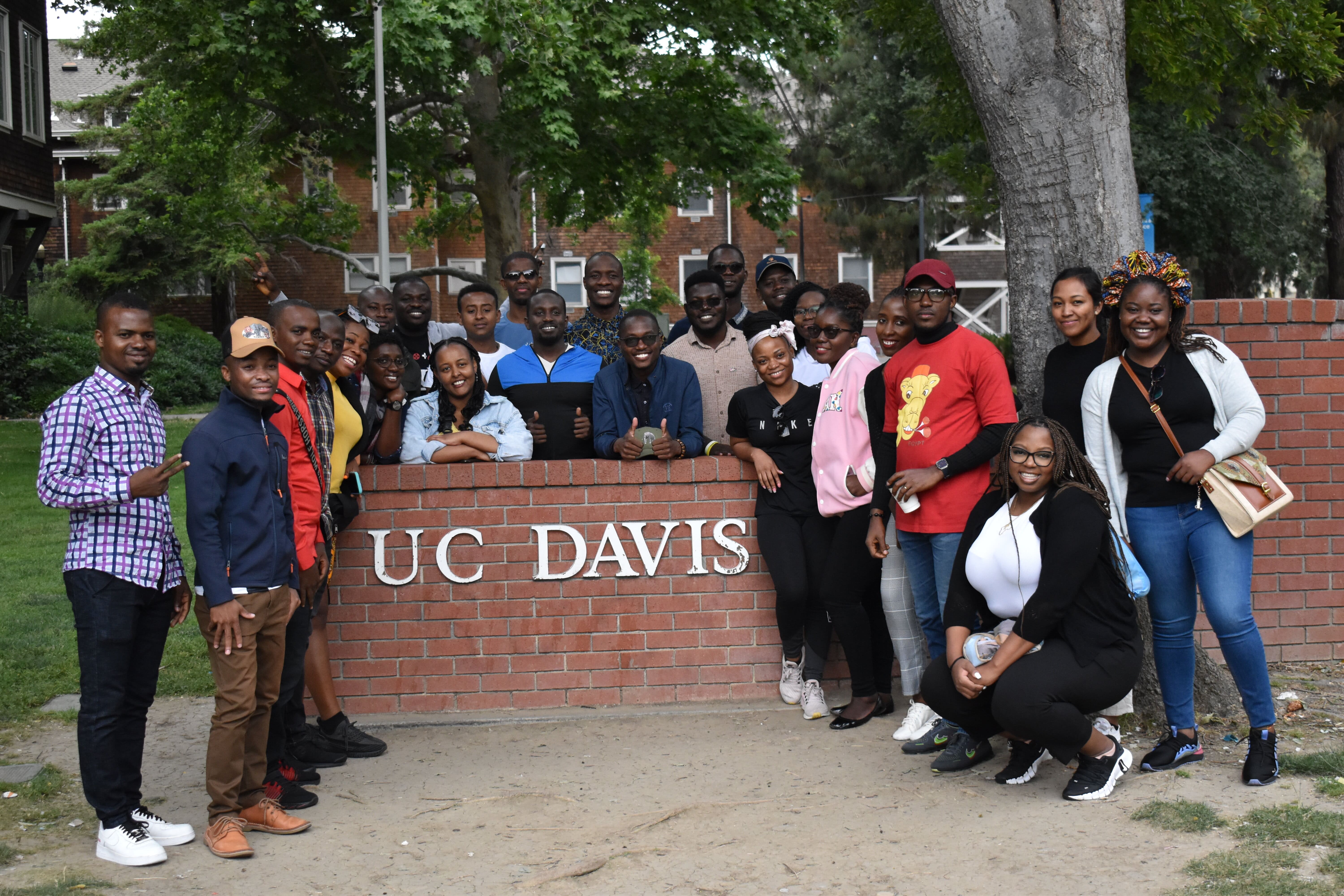 The Fellows gather around a brick UC Davis welcome sign.