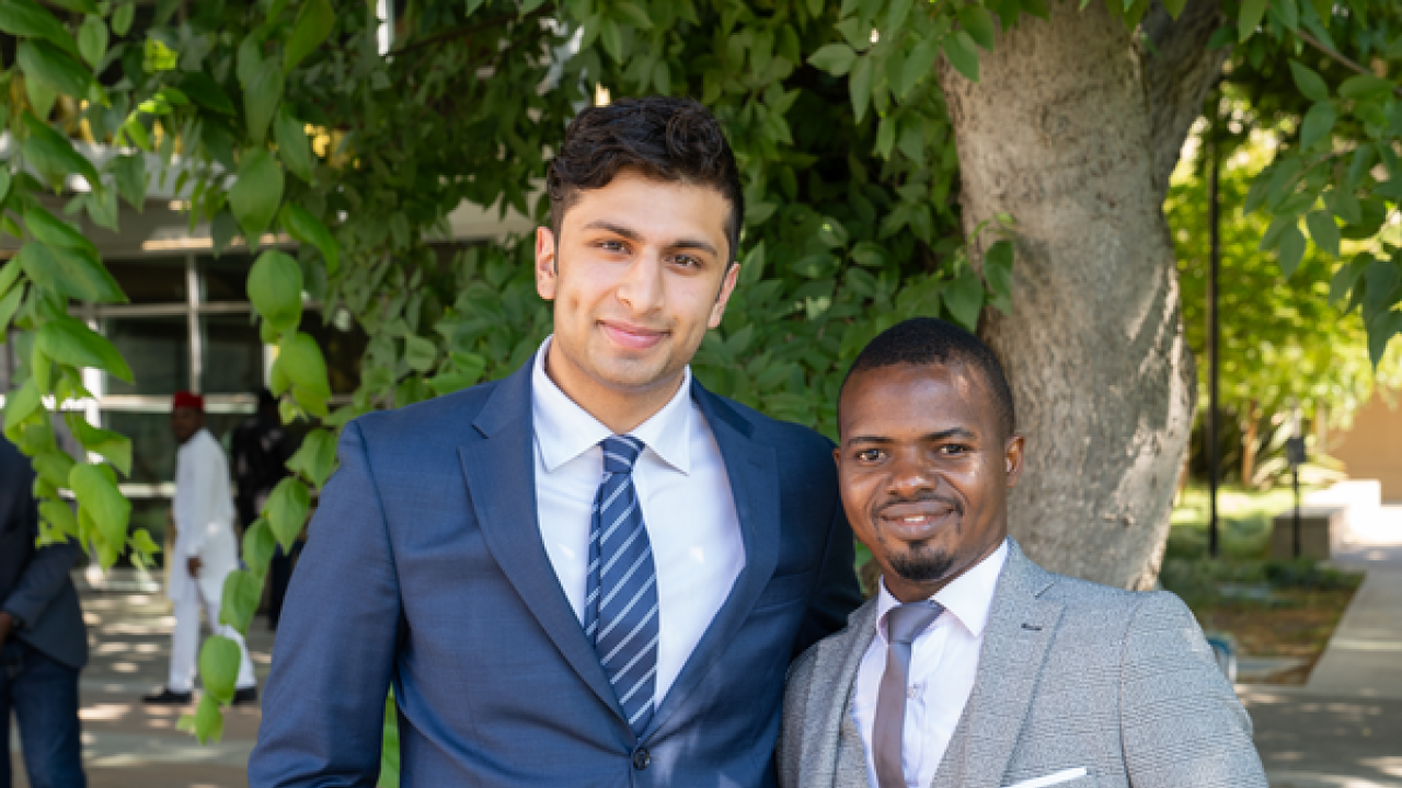 Zain Patel stands with a Mandela Washington Fellow, Sévérin Ekpe, at the Mandela Washington Fellows Welcome Event outside the International Center. 
